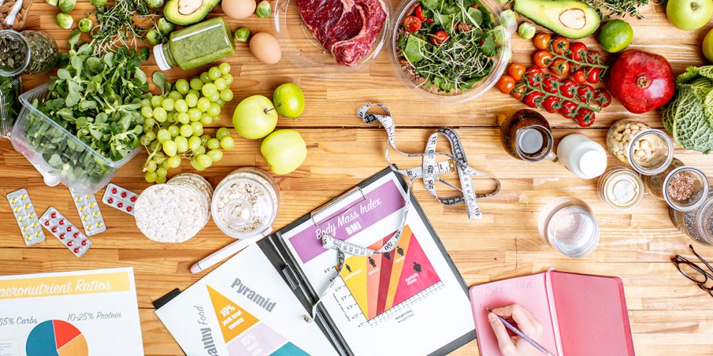 writing-a-diet-plan-on-the-table-full-of-healthy-resize.jpg